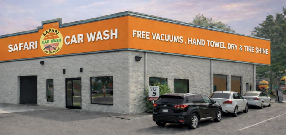 The Safari Car Wash building in Franklin, its orange sign reading Free Vacuums, Hand Towel Dry and Tire Shine.
